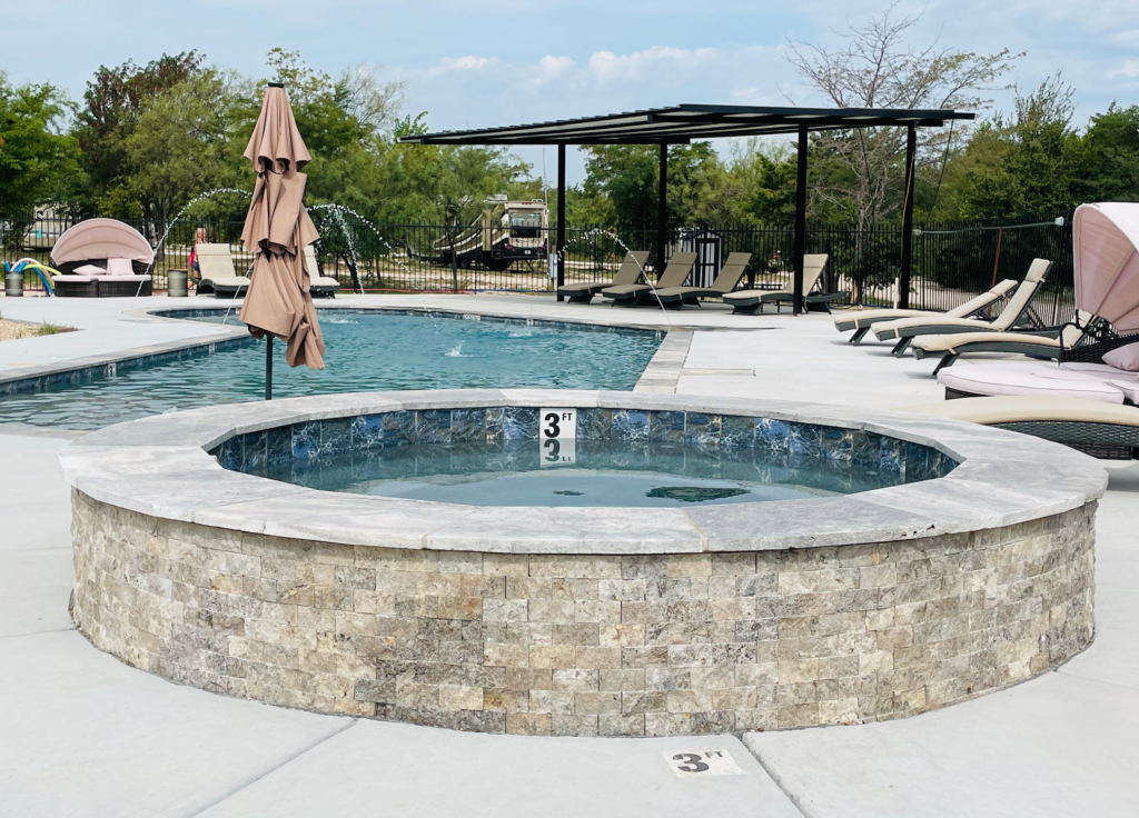 batl ranch pool area with heated spa and cover and seating