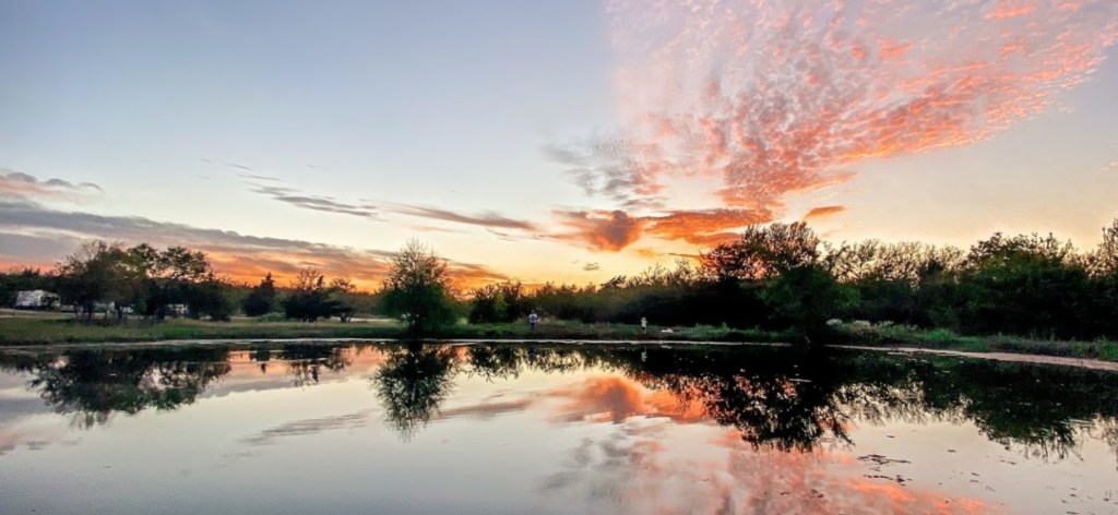 Beautiful Sunset over large pond at batl ranch