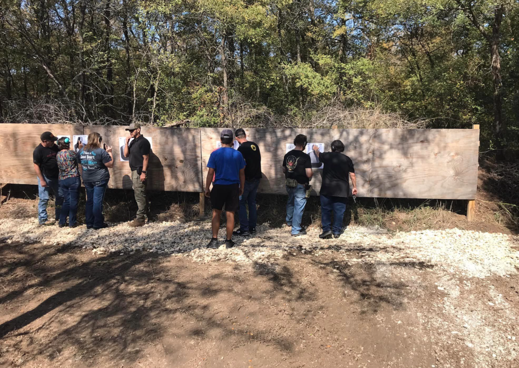 group enjoying a live fire event with trainer at batl ranch