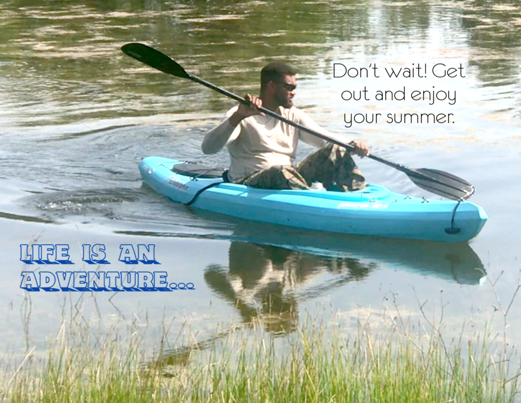 man kayaking in small pond on sunny day